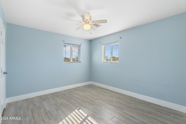 spare room with ceiling fan and light hardwood / wood-style flooring