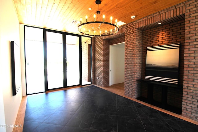 7341 E Sunnyside Dr, Scottsdale, AZ 85260 - unfurnished living room featuring wood ceiling, brick wall, a chandelier, tile patterned flooring, and french doors