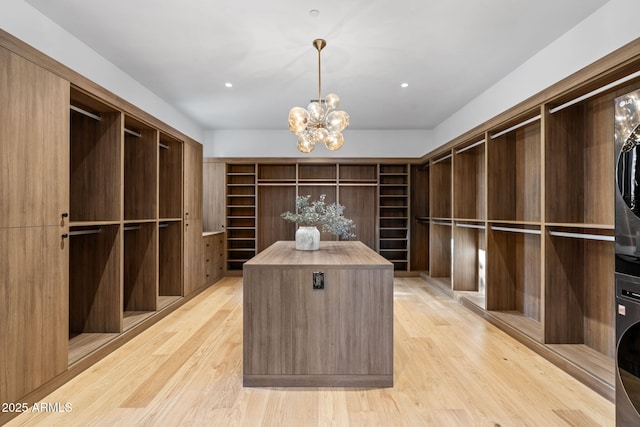 7341 E Sunnyside Dr, Scottsdale, AZ 85260 - spacious closet with light wood-style floors and a chandelier