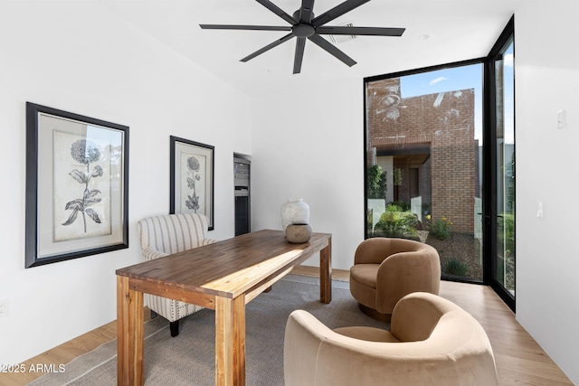 7341 E Sunnyside Dr, Scottsdale, AZ 85260 - dining room featuring floor to ceiling windows, healthy amount of natural light, a ceiling fan, and light wood-style floors