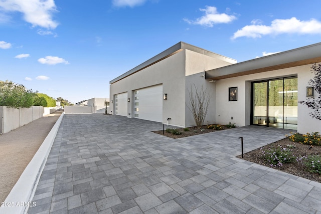 7341 E Sunnyside Dr, Scottsdale, AZ 85260 - view of property exterior with stucco siding, decorative driveway, and a garage