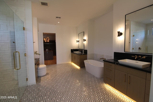 7341 E Sunnyside Dr, Scottsdale, AZ 85260 - full bathroom featuring a stall shower, two vanities, a soaking tub, and a chandelier