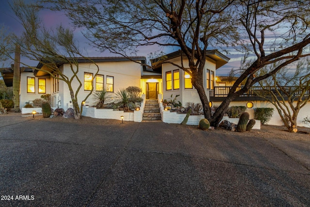 view of front of property featuring aphalt driveway and brick siding