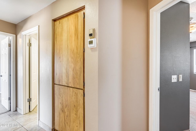 hall featuring light tile patterned flooring