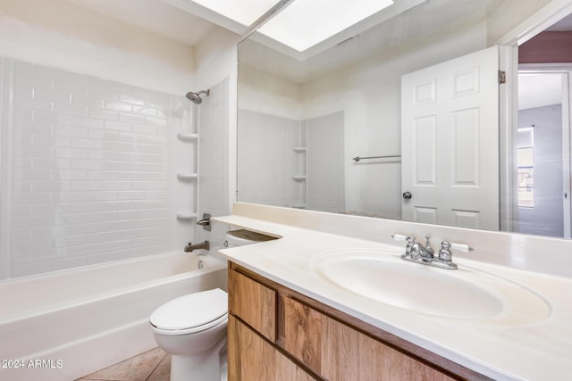 bathroom with tile patterned flooring, toilet, shower / bath combination, a skylight, and vanity