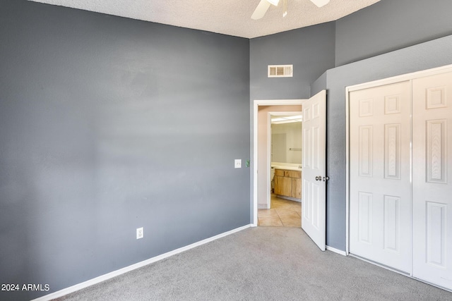 unfurnished bedroom with visible vents, baseboards, a closet, and carpet flooring