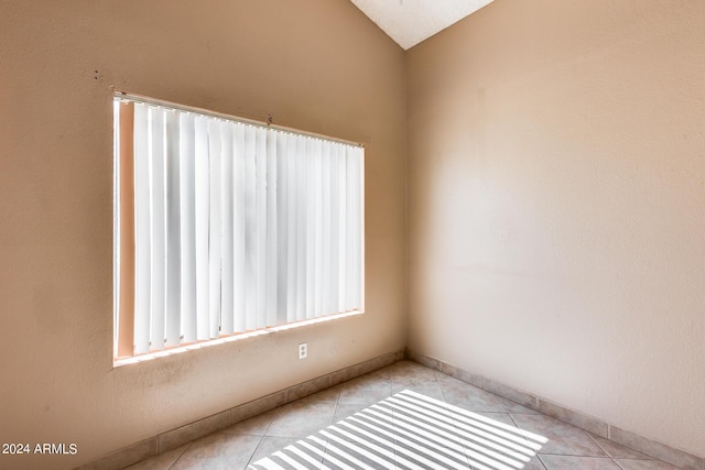 unfurnished room featuring light tile patterned floors and baseboards