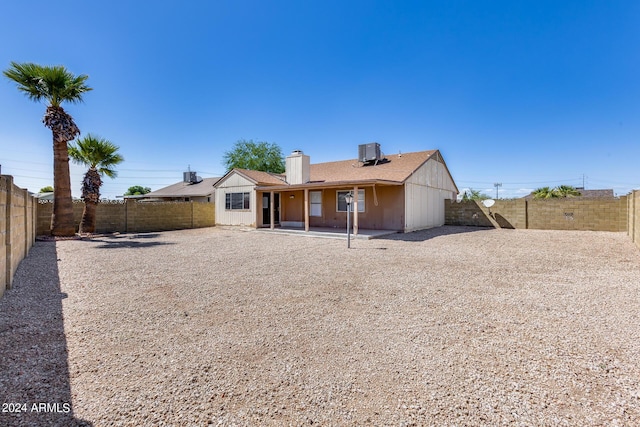 back of property featuring central AC unit, a fenced backyard, and a patio area