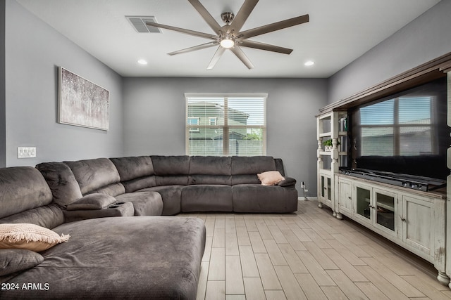 living room with ceiling fan and light wood-type flooring