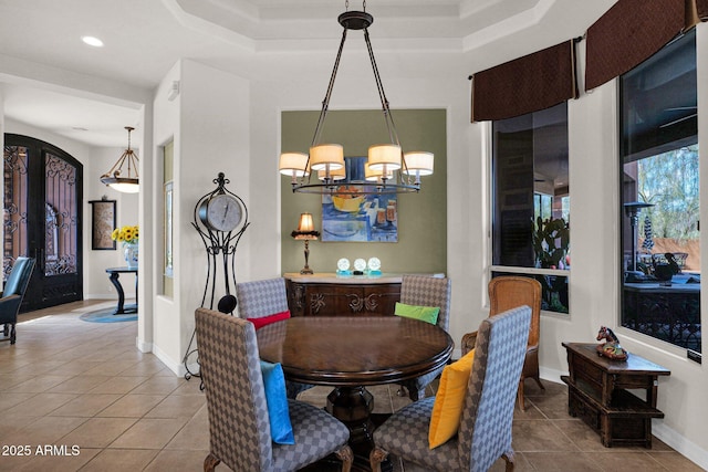 dining space featuring arched walkways, a notable chandelier, baseboards, and tile patterned floors