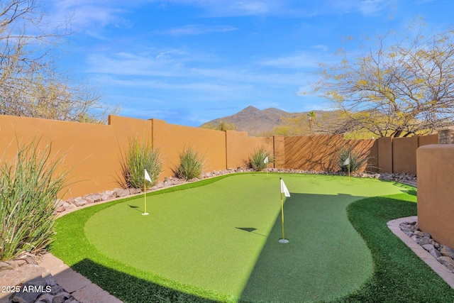 view of yard featuring a fenced backyard and a mountain view