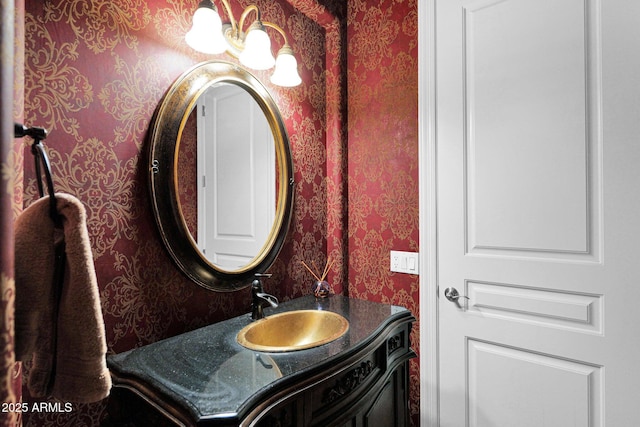 bathroom with vanity and wallpapered walls