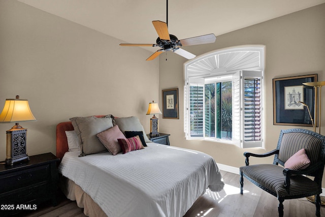 bedroom featuring ceiling fan, wood finished floors, and baseboards