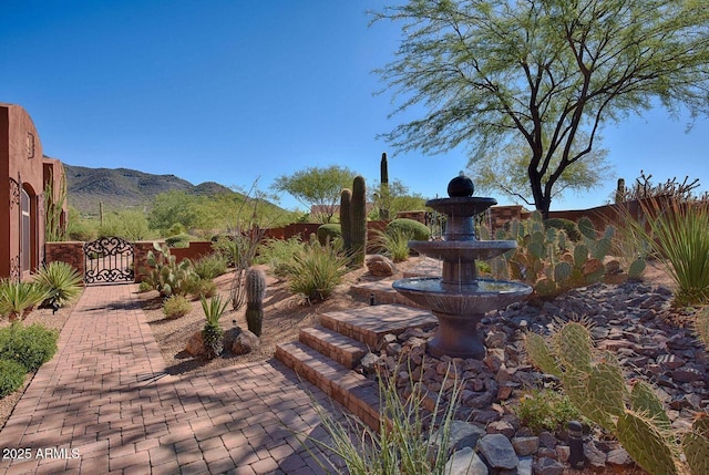 view of patio / terrace featuring a gate, fence, and a mountain view