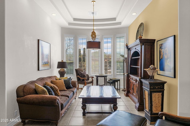 living room featuring light tile patterned floors, recessed lighting, a raised ceiling, visible vents, and baseboards