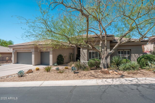 12366 N 129th St, Scottsdale, AZ 85259 - prairie-style house featuring stucco siding, a garage, and driveway