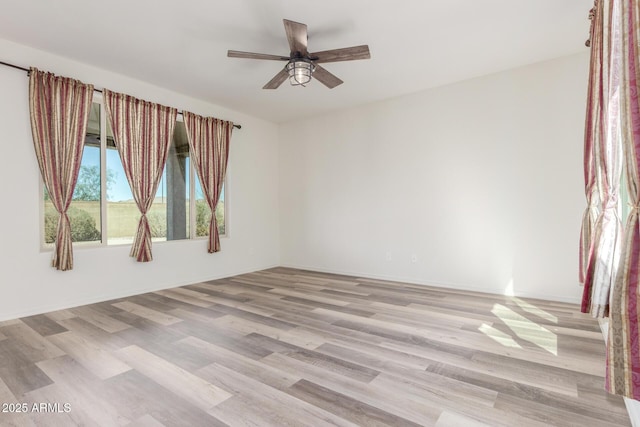 spare room featuring ceiling fan and light wood-type flooring