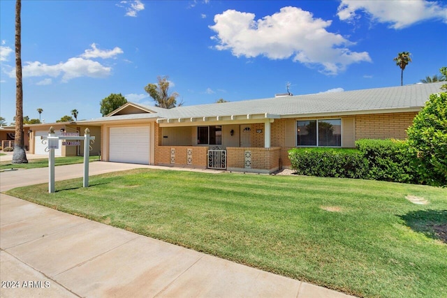 single story home with a garage and a front lawn