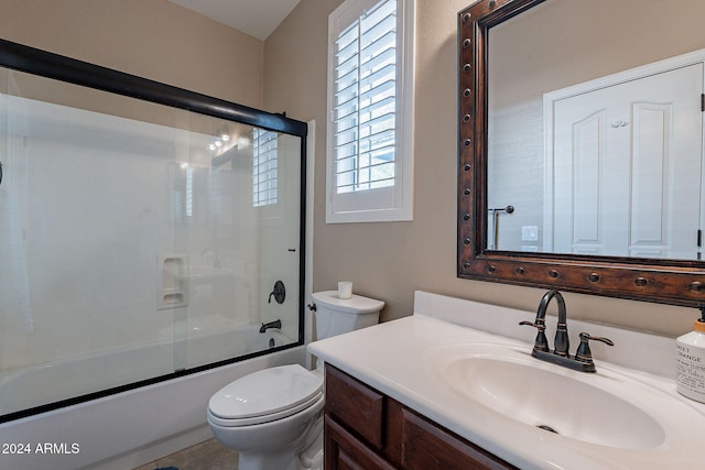 full bathroom with toilet, vanity, and enclosed tub / shower combo