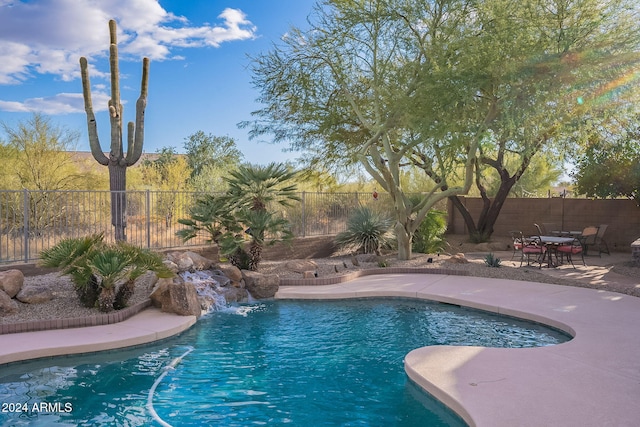 view of pool with a patio area and pool water feature