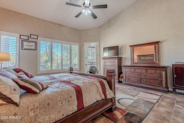 bedroom with a towering ceiling and ceiling fan