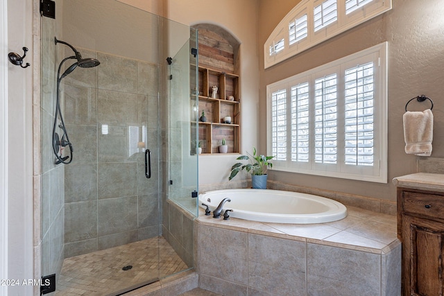 bathroom featuring independent shower and bath