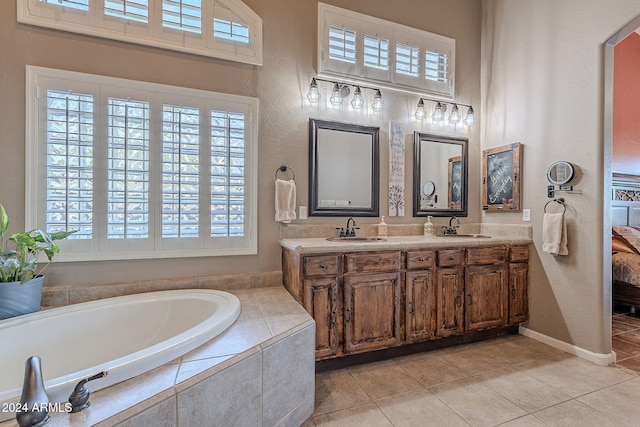 bathroom featuring vanity, tiled tub, and tile patterned floors