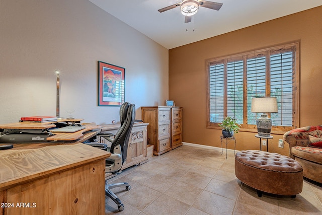 tiled home office featuring ceiling fan and vaulted ceiling