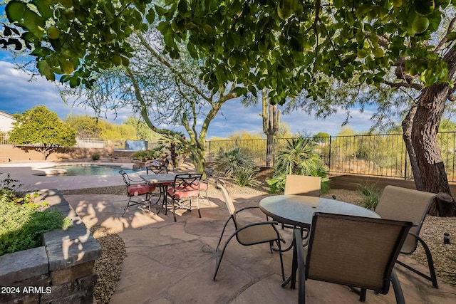 view of patio with a fenced in pool