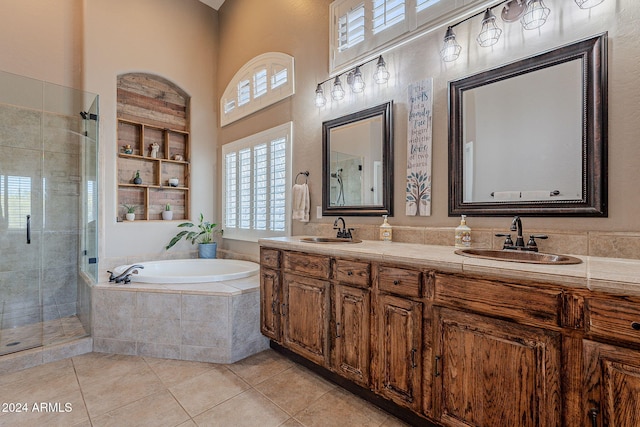 bathroom featuring a towering ceiling, tile patterned flooring, shower with separate bathtub, and vanity