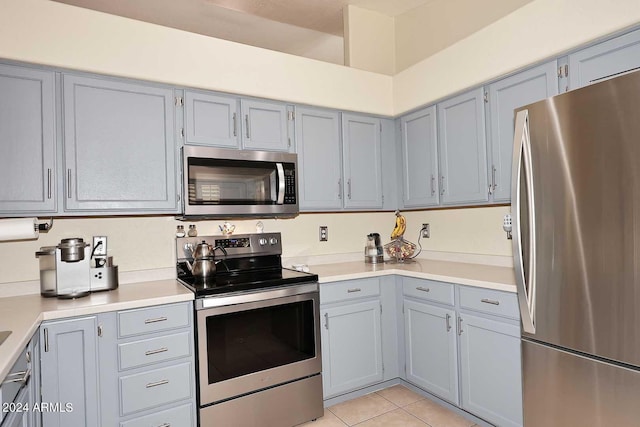 kitchen featuring light tile patterned floors and appliances with stainless steel finishes