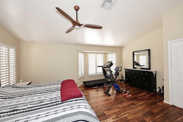 bedroom featuring dark wood-type flooring, vaulted ceiling, and ceiling fan