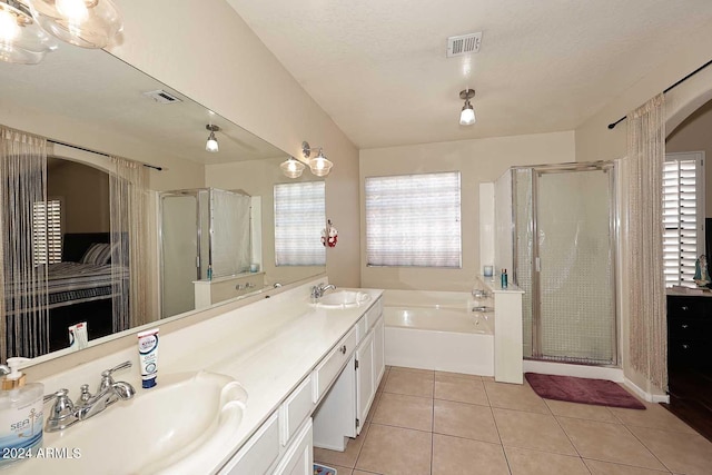 bathroom featuring a textured ceiling, shower with separate bathtub, vanity, and tile patterned floors