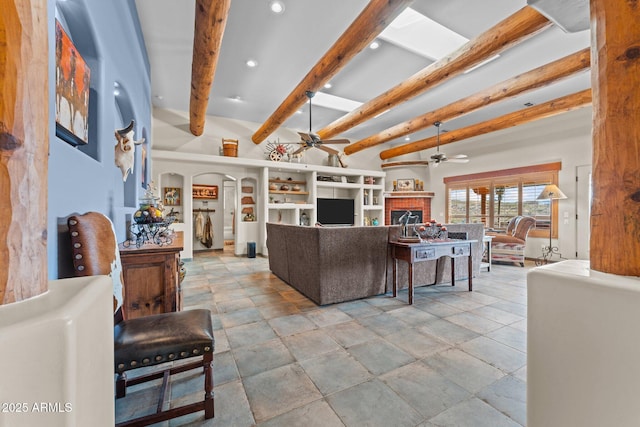 living area with a brick fireplace, beam ceiling, recessed lighting, arched walkways, and a ceiling fan