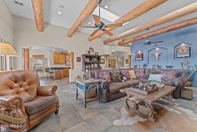 living room with visible vents, beam ceiling, recessed lighting, arched walkways, and ceiling fan