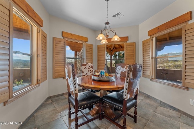 dining area featuring plenty of natural light, baseboards, visible vents, and a chandelier