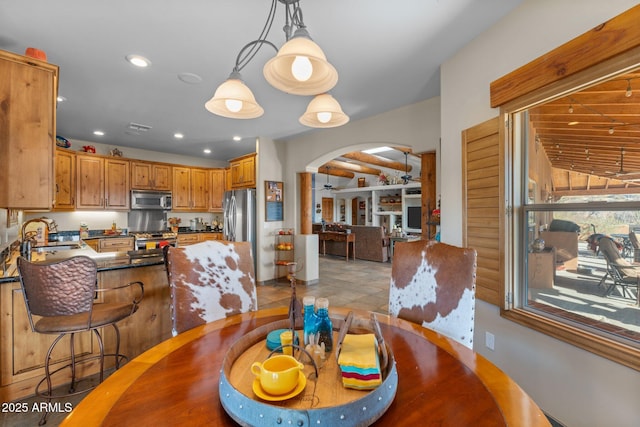 dining space with visible vents, recessed lighting, and arched walkways