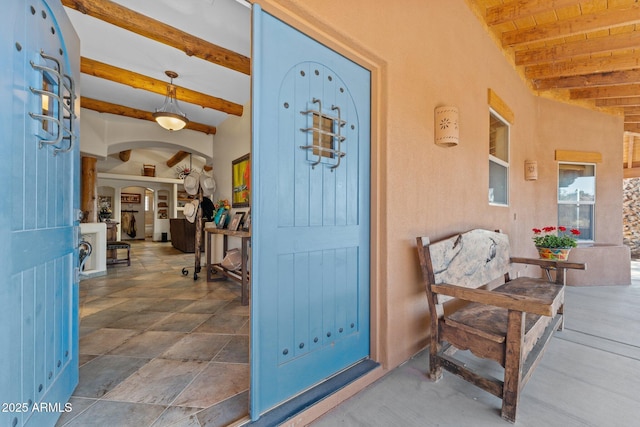 doorway to property featuring stucco siding