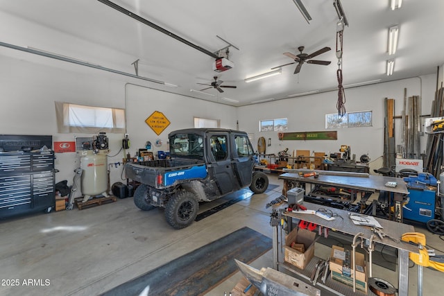 garage with a workshop area and a garage door opener