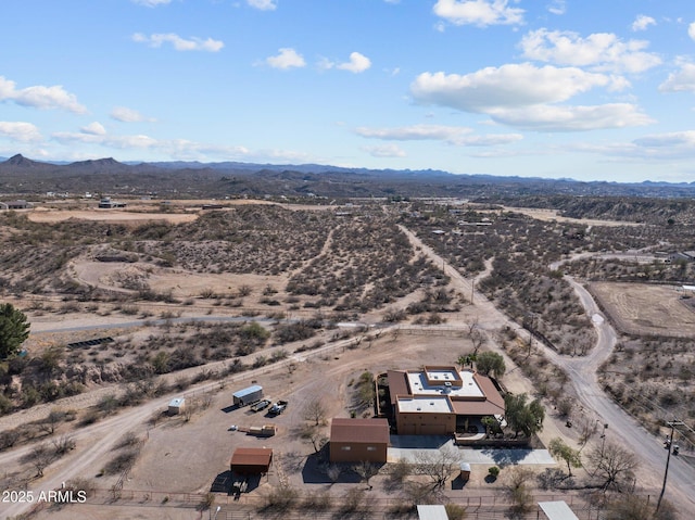 drone / aerial view featuring a mountain view and a desert view