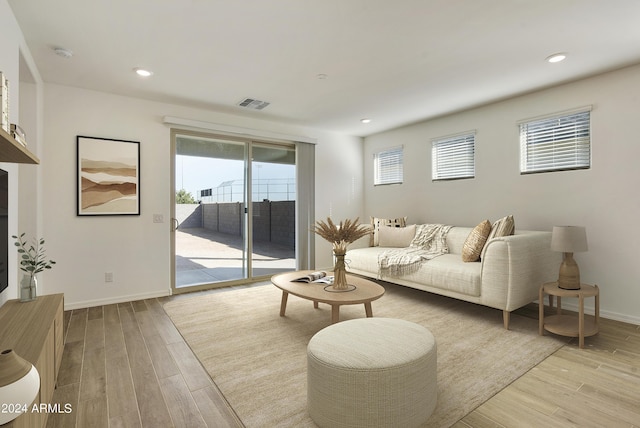 living room featuring recessed lighting, visible vents, light wood-style flooring, and baseboards