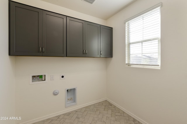 laundry room with hookup for a washing machine, hookup for a gas dryer, cabinet space, electric dryer hookup, and baseboards