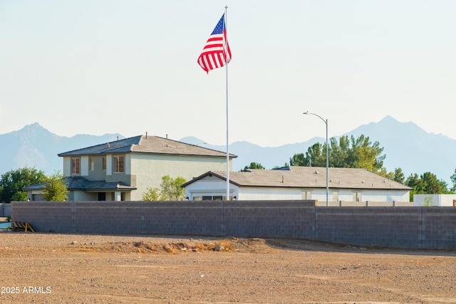 view of yard featuring fence and a mountain view