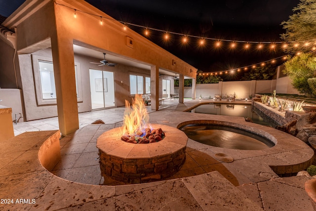 view of patio with a swimming pool with hot tub, an outdoor fire pit, and ceiling fan