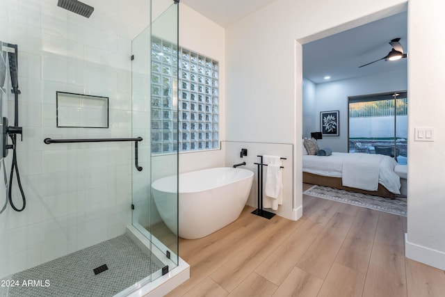 bathroom featuring hardwood / wood-style floors, ceiling fan, and separate shower and tub