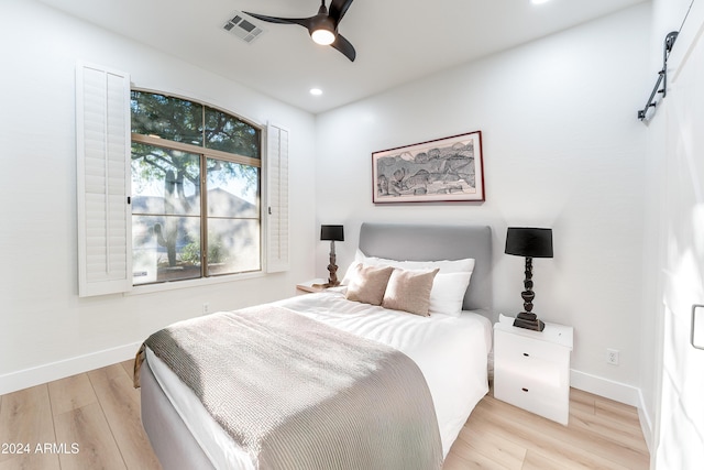 bedroom featuring light hardwood / wood-style floors and ceiling fan