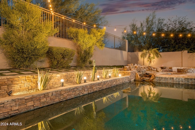 view of pool at dusk