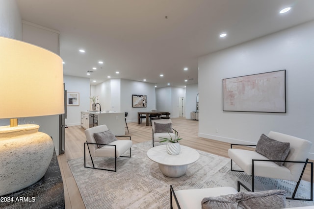 living room featuring light wood-type flooring and sink