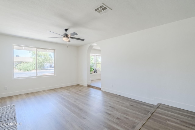 2337 E Contessa St, Mesa, AZ 85213 - spare room featuring arched walkways, light wood finished floors, and a ceiling fan