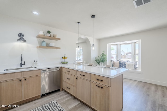 2337 E Contessa St, Mesa, AZ 85213 - kitchen with dishwasher, light brown cabinets, a peninsula, arched walkways, and light wood finished floors